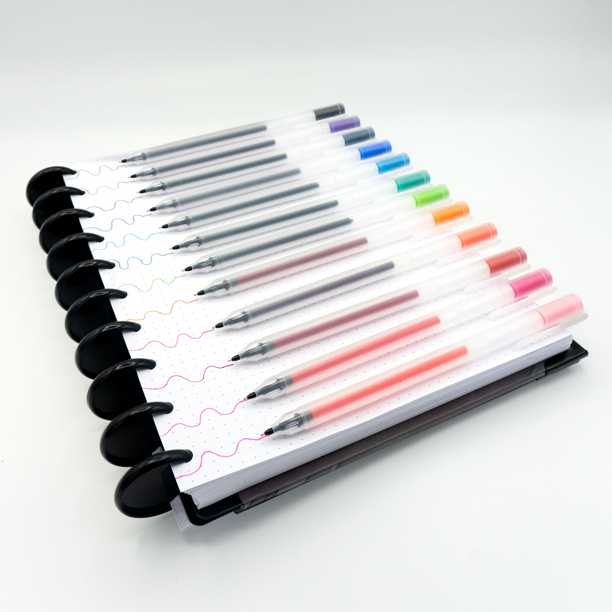 Twelve pens and their colors on paper