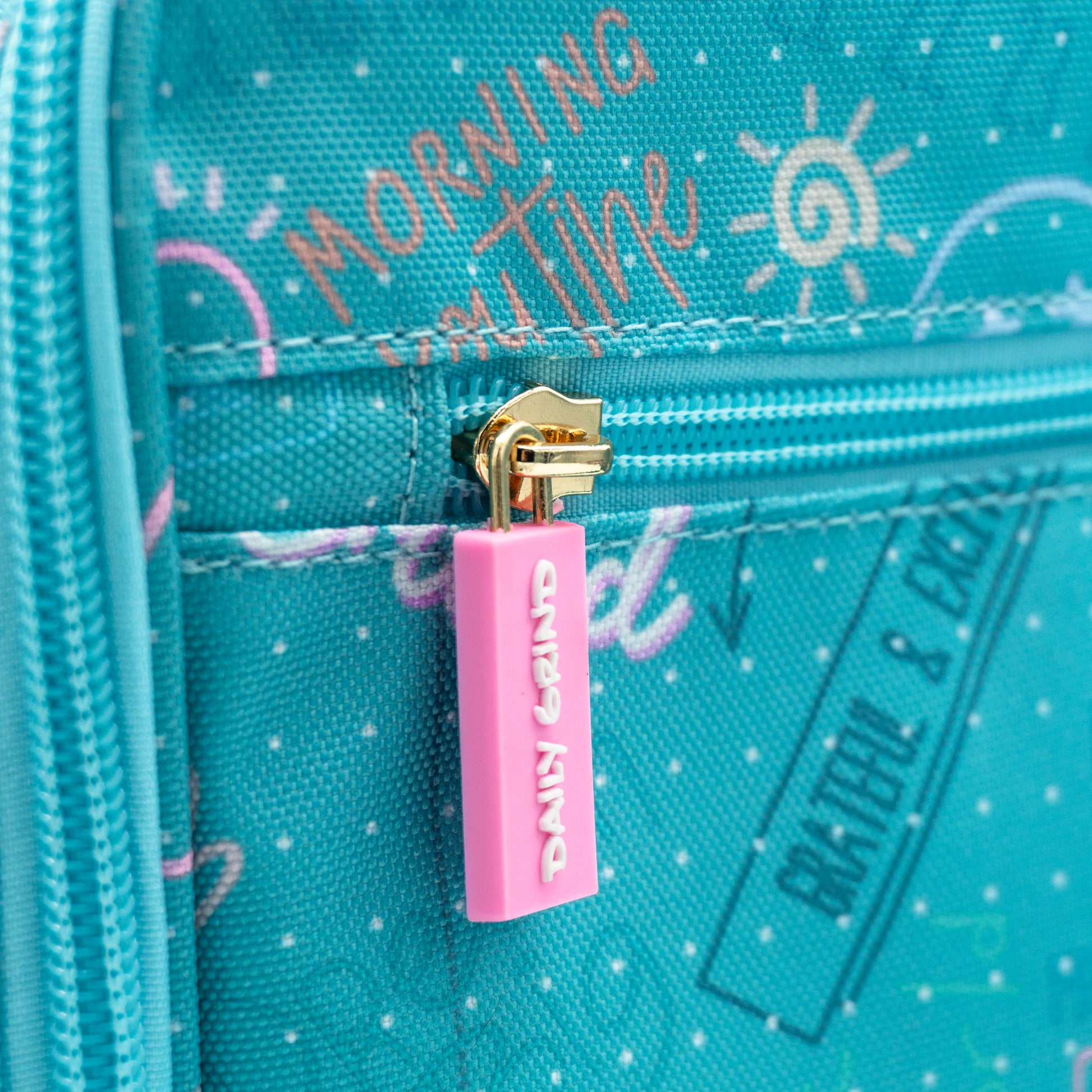 Close up of "Daily Grind" zipper pull