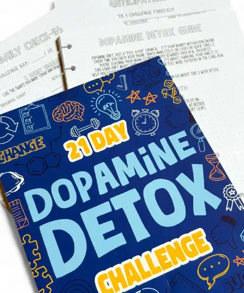 Book titled '21 Day Dopamine Detox Challenge' on a surface with printed materials.