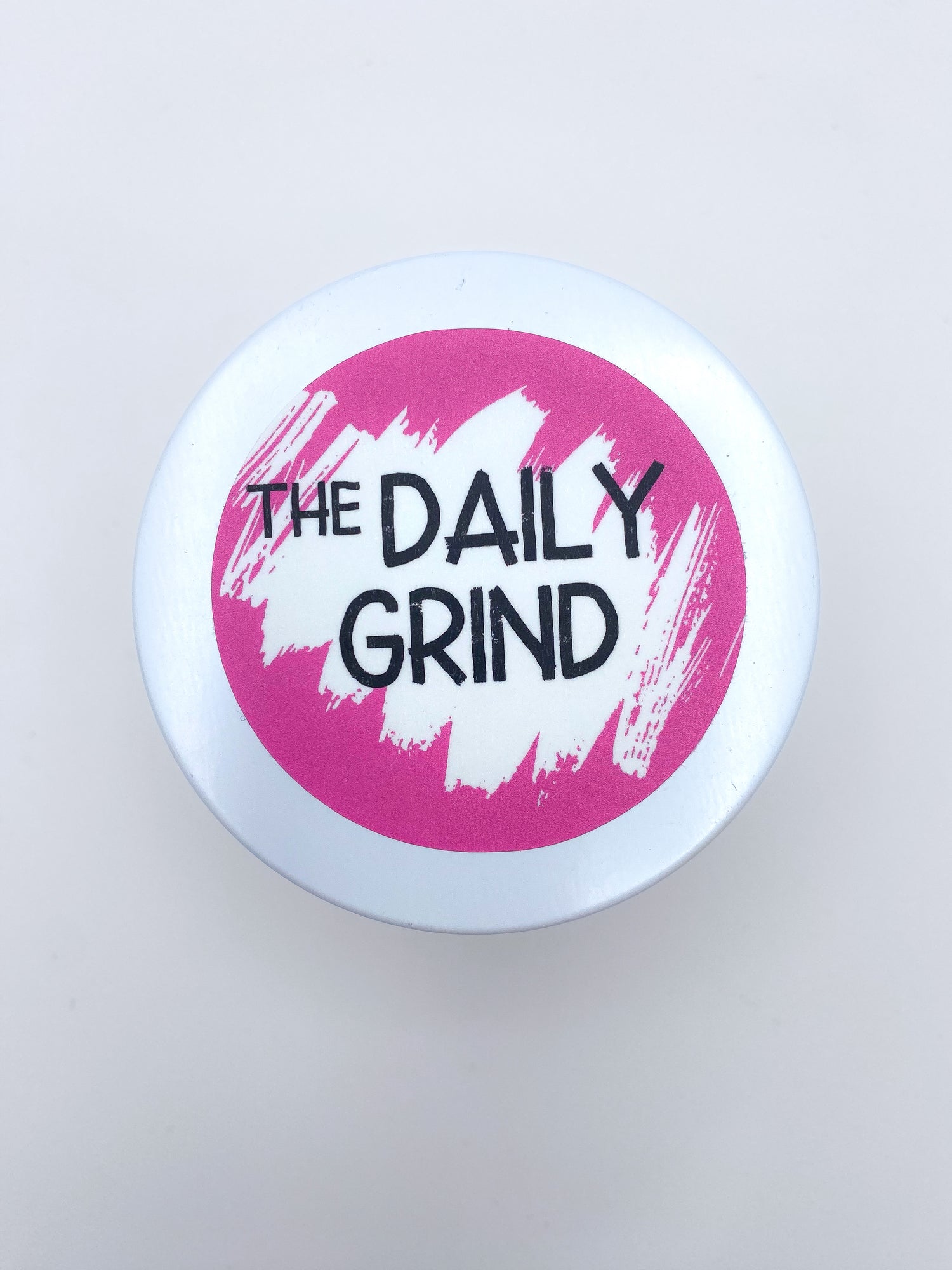 &quot;The Daily Grind&quot; white candle lid with pink label