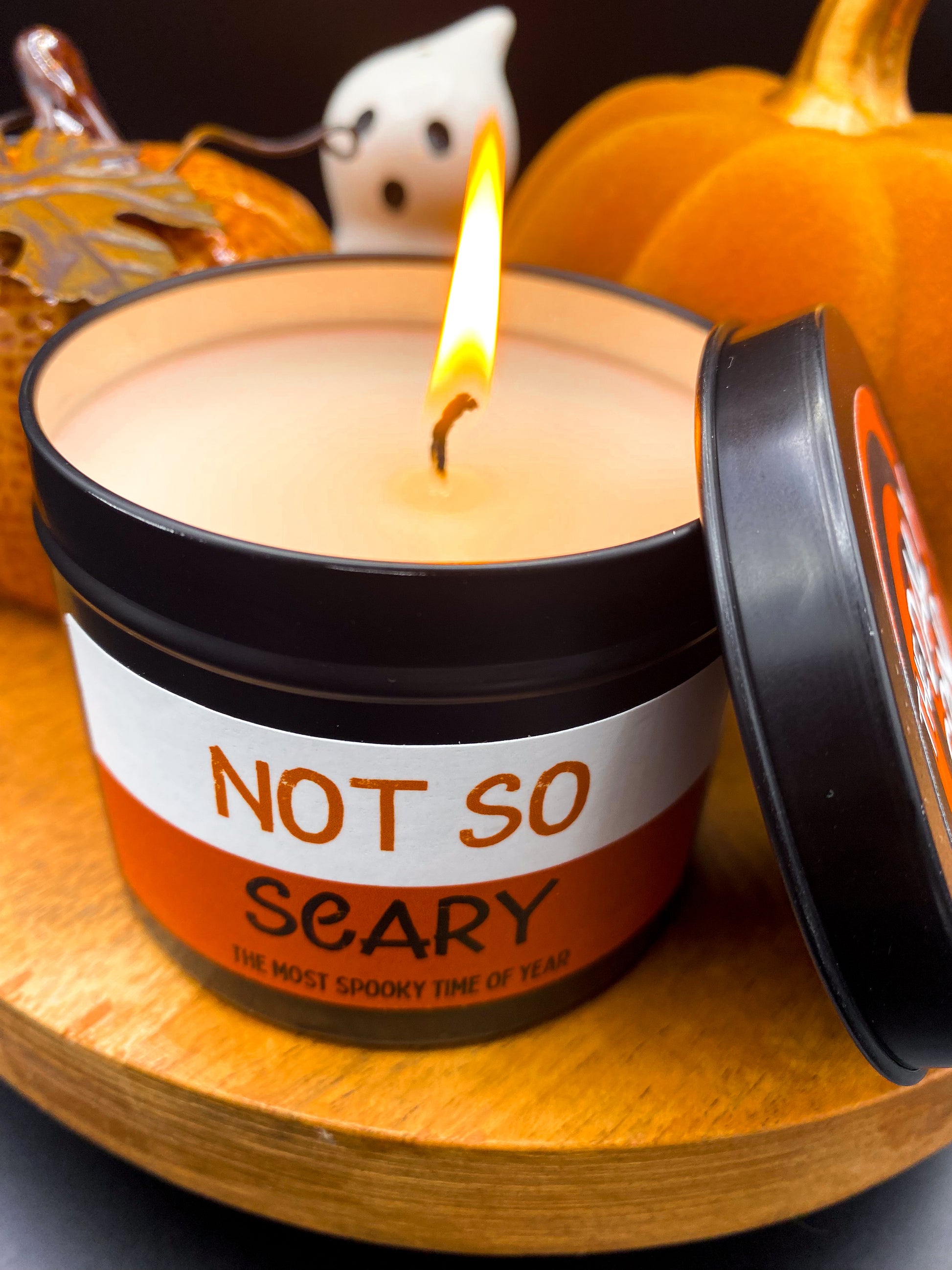 Lit "Not So Scary" candle in black tin