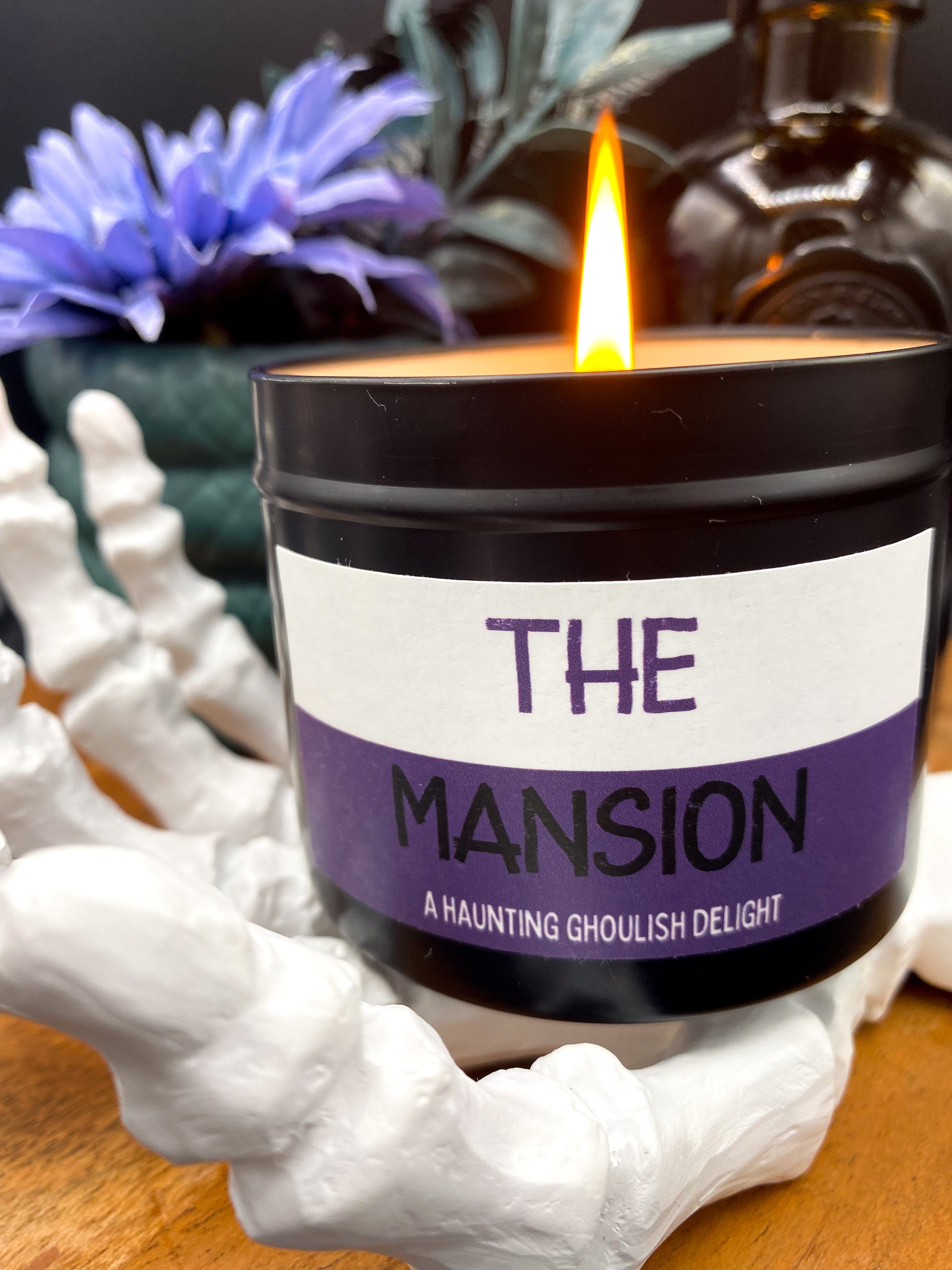Lit &quot;The Mansion&quot; candle in black tin