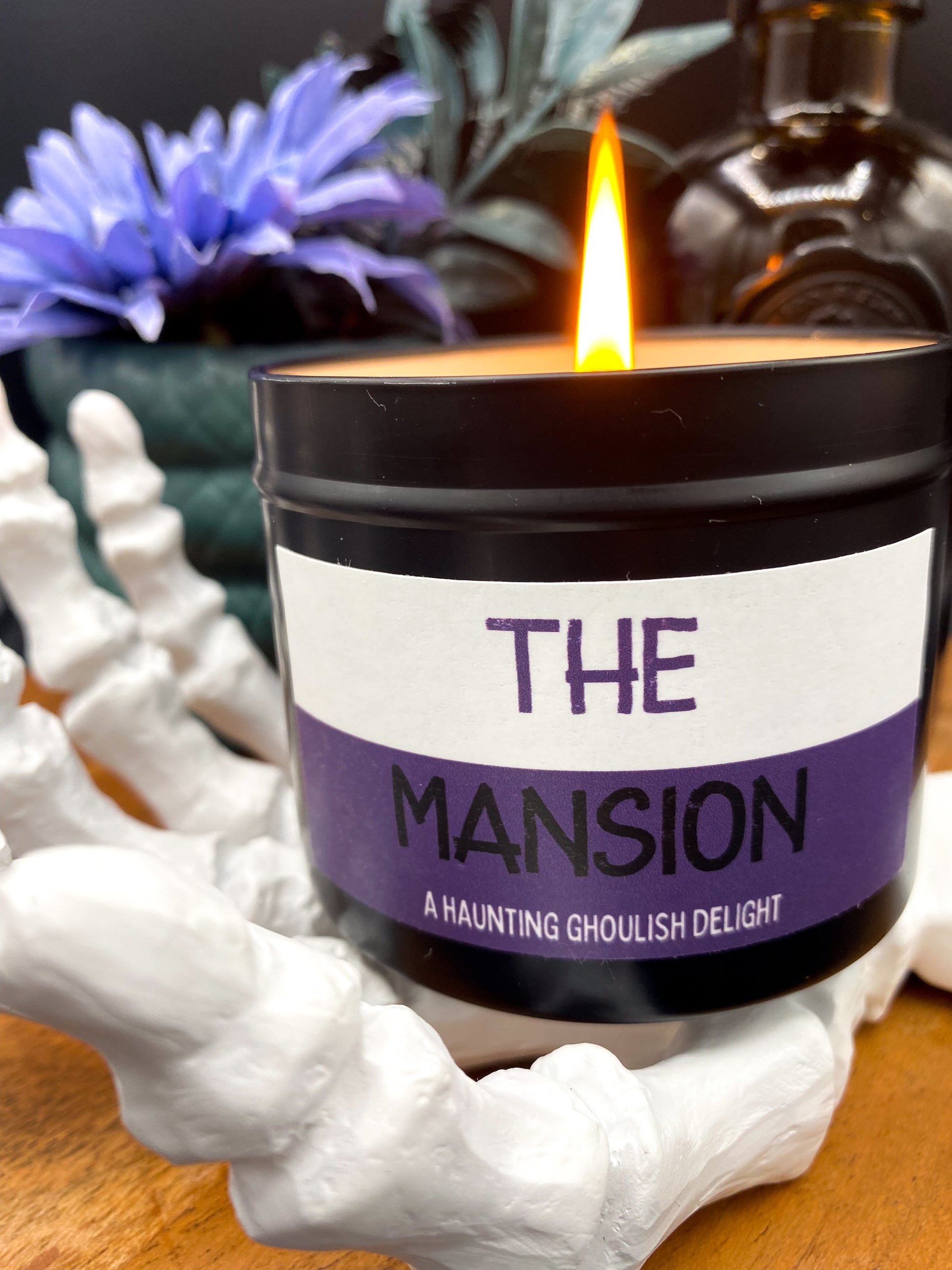 Lit "The Mansion" candle in black tin