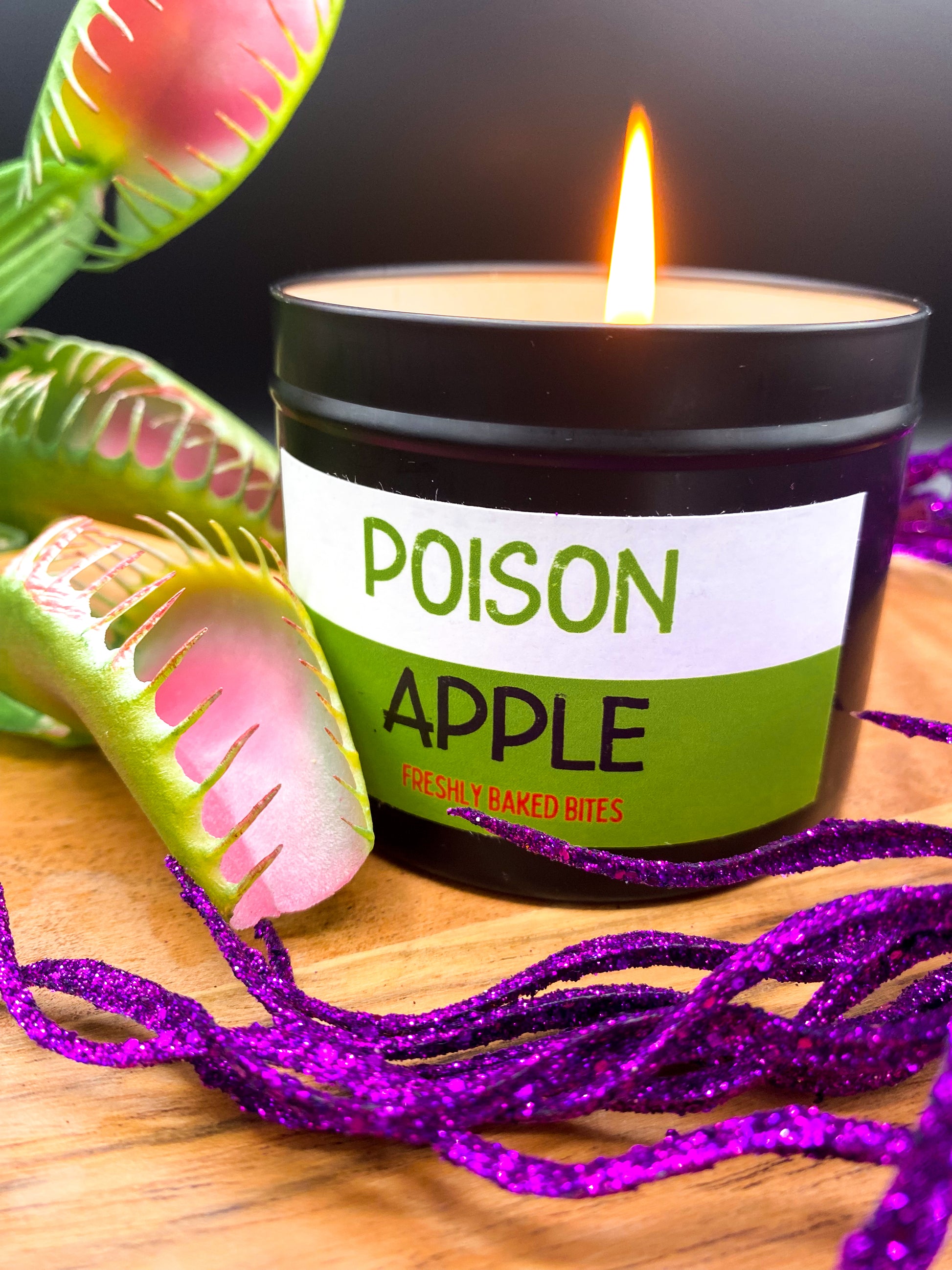 Lit "Poison Apple" candle in black tin