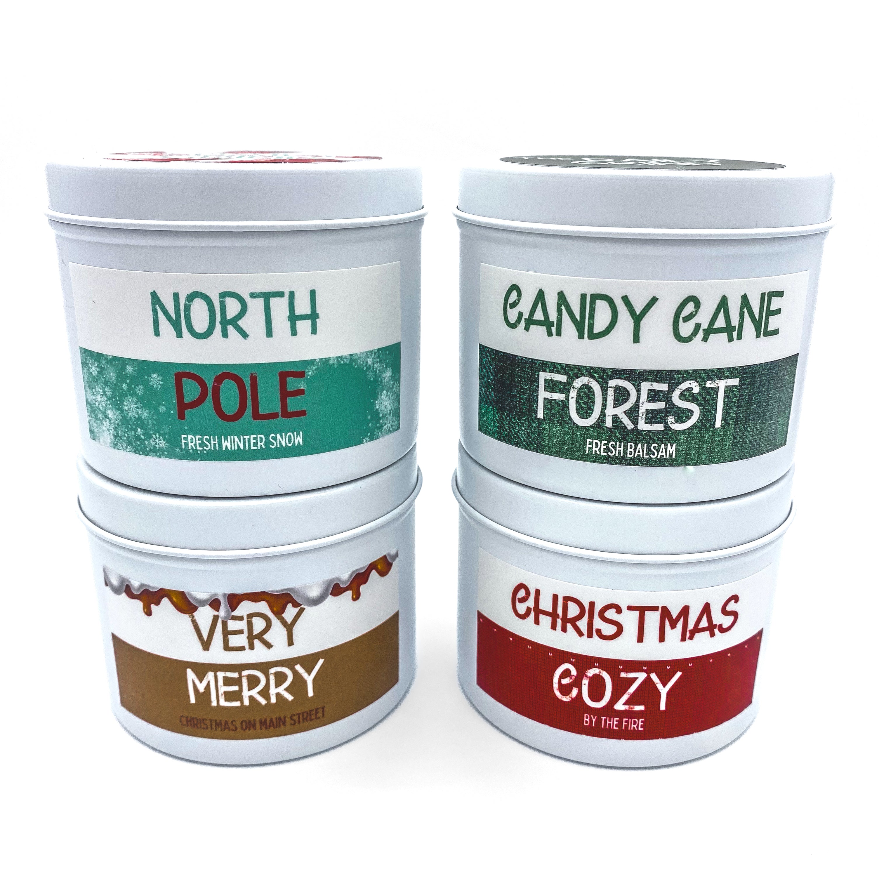 Set of four holiday candles in white tins