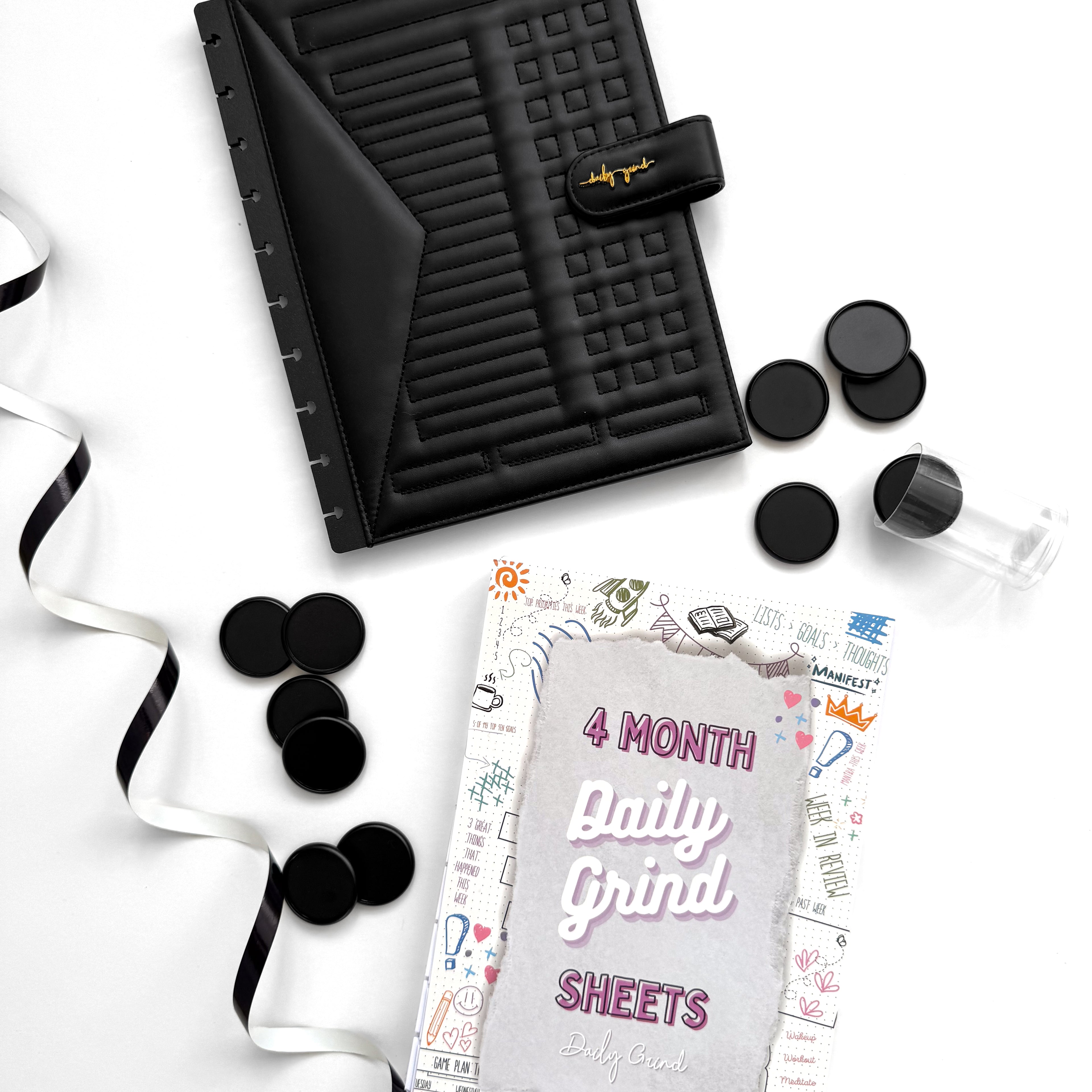 Black planner cover and discs with &quot;4 Month Daily Grind Sheets&quot; insert