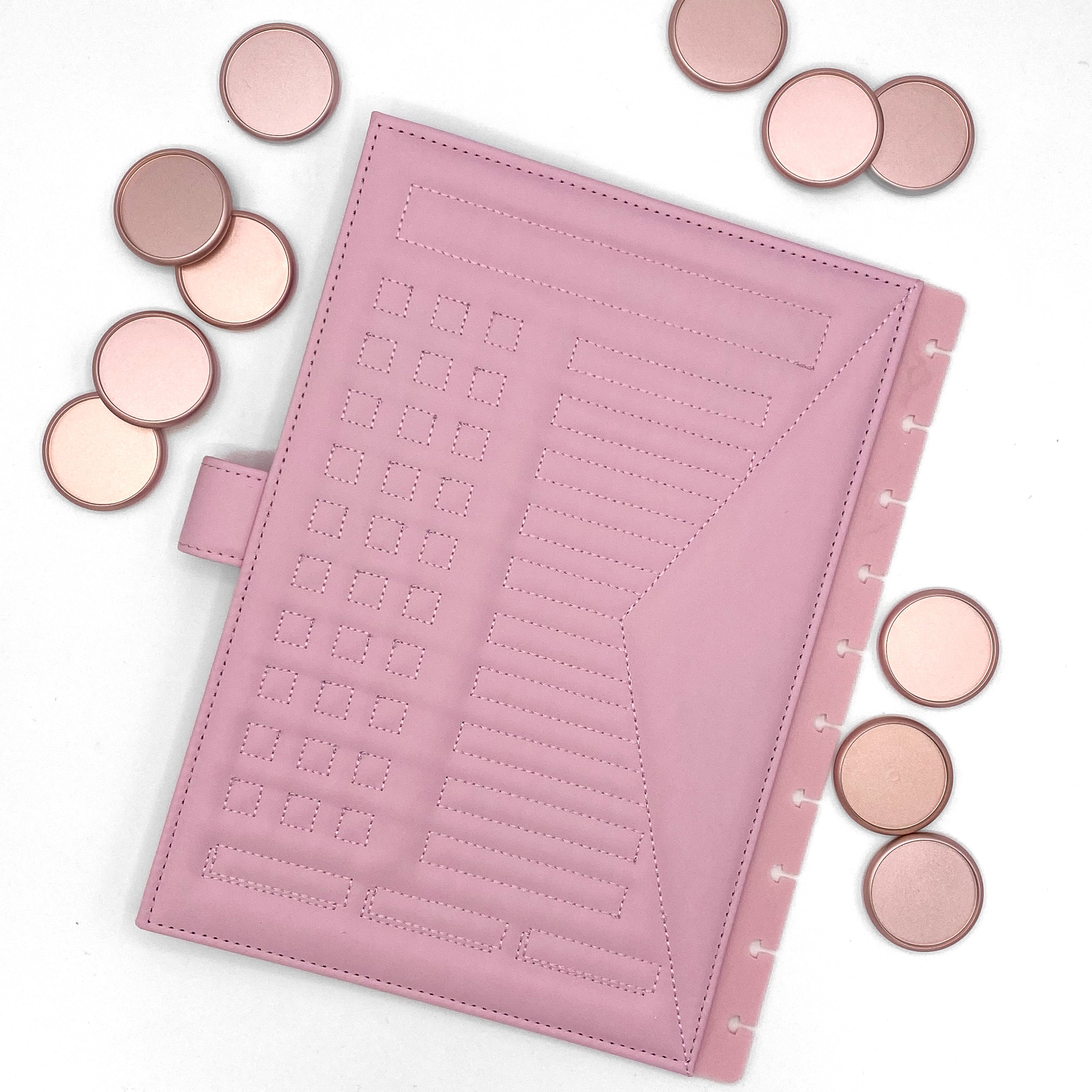 Back cover of pink faux leather planner and rose gold discs