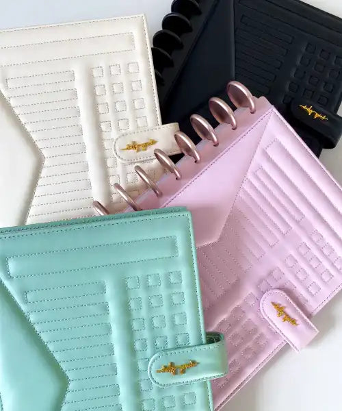 Collection of planners in various colors with a textured cover design.