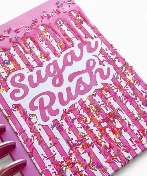 Pink planner cover with 'Sugar Rush' text and colorful design on a white background